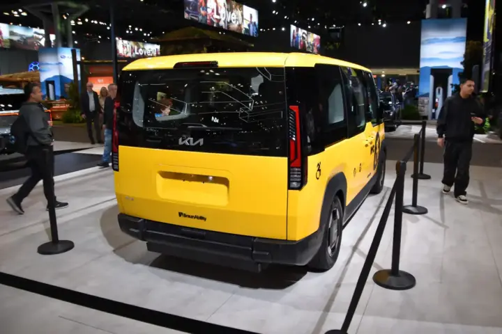 Kia PV-5 concept electric van displayed at an auto show, the vehicle family that includes the new Kia PV7 commercial electric van.