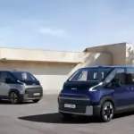 Kia PV5 passenger van (blue) and CV5 cargo van (silver) electric vehicles, the models behind Kia's commercial EV lineup including the PV7.