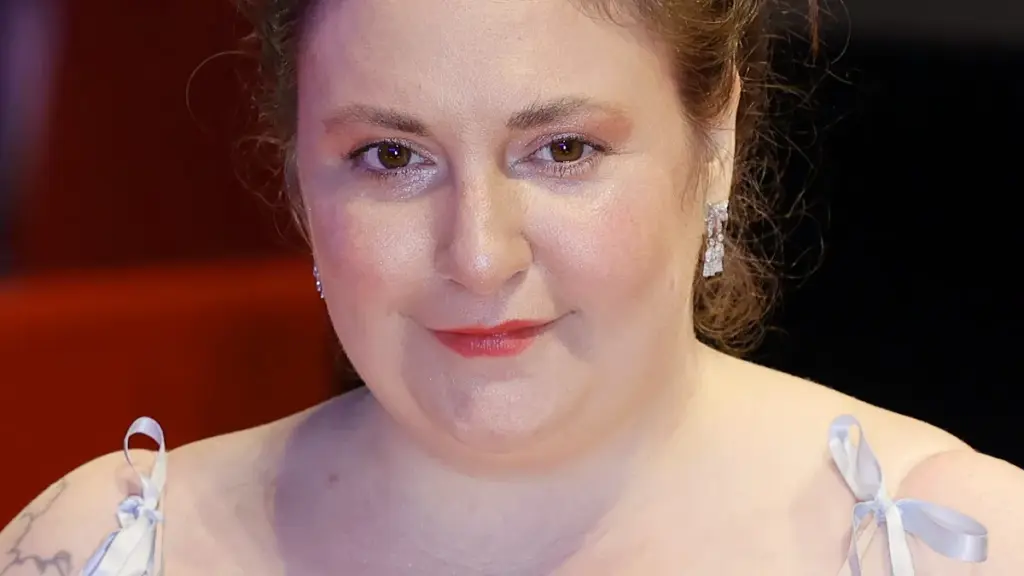 Actress, writer, and director Lena Dunham smiling on the red carpet during the 74th Berlin International Film Festival.
