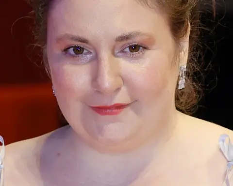 Actress writer and director Lena Dunham smiling on the red carpet at the Berlinale International Film Festival representing major film events and cultural celebrations.