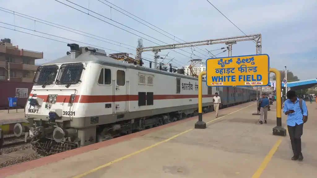 Indian Railways electric locomotive at a railway station.