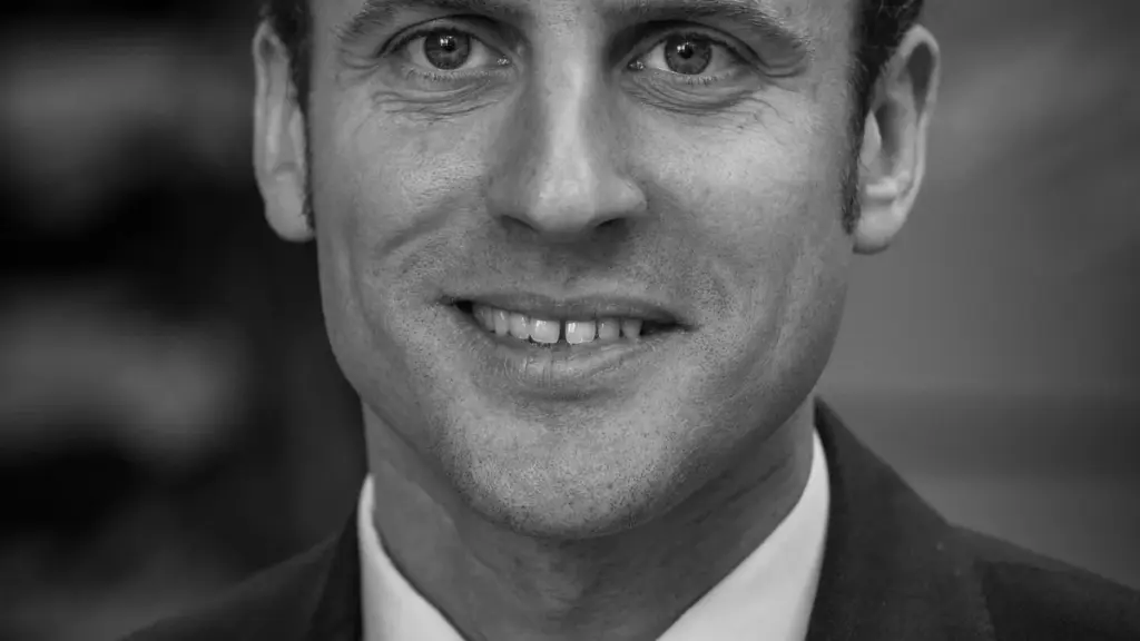 Portrait of French President Emmanuel Macron in a dark suit.