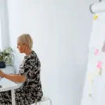 Woman seated in a chair representing menopause brain health and memory research.