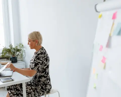 Woman seated in a chair representing menopause brain health and memory research.