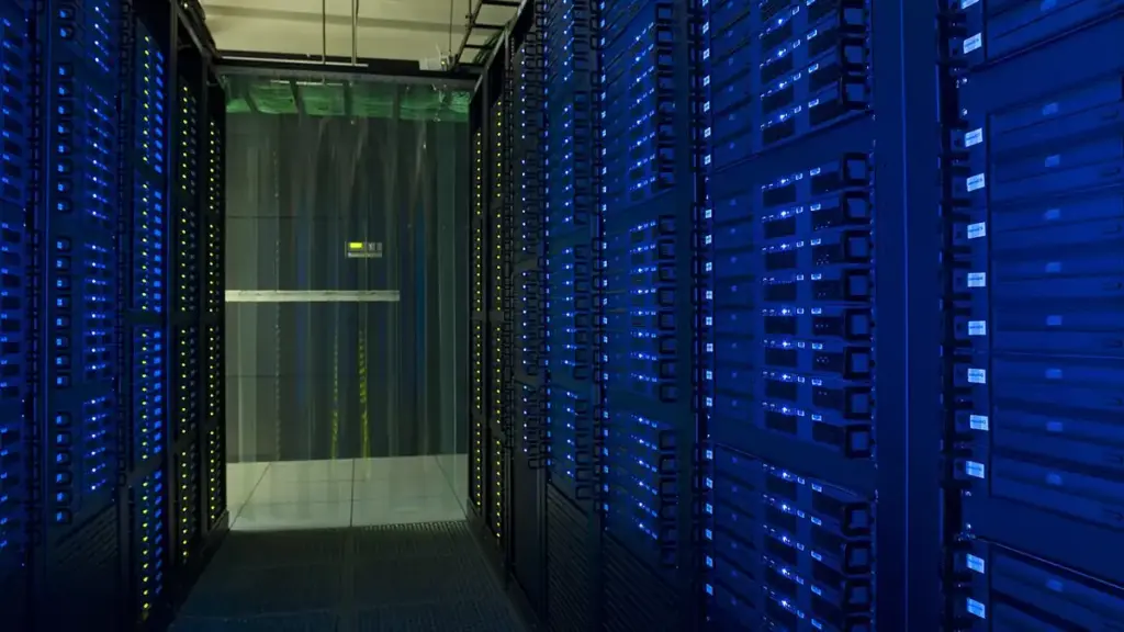 Racks of network servers and glowing fiber-optic cabling in a high-density enterprise data center.