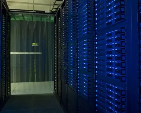 Racks of network servers and glowing fiber-optic cabling in a high-density enterprise data center.