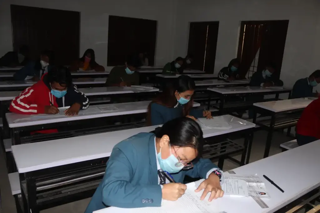 Students seated at desks while taking a Grade 12 written examination