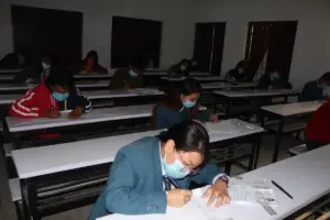 Students seated at desks while taking a Grade 12 written examination