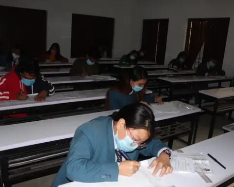 Students seated at desks while taking a Grade 12 written examination