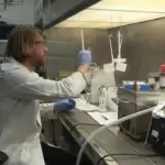 A scientist working in a laboratory, representing the research environment behind the US $144 million microplastics research initiative.