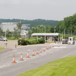 Exterior entrance and security gates of the NATS London Area Control Centre facility in Swanwick, Hampshire.