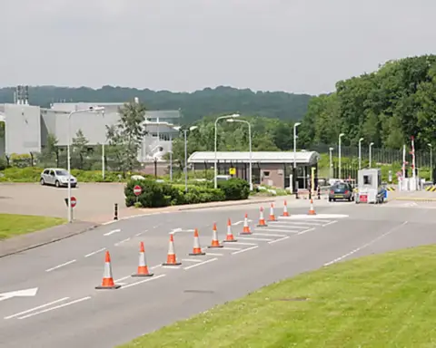 Exterior entrance and security gates of the NATS London Area Control Centre facility in Swanwick, Hampshire.