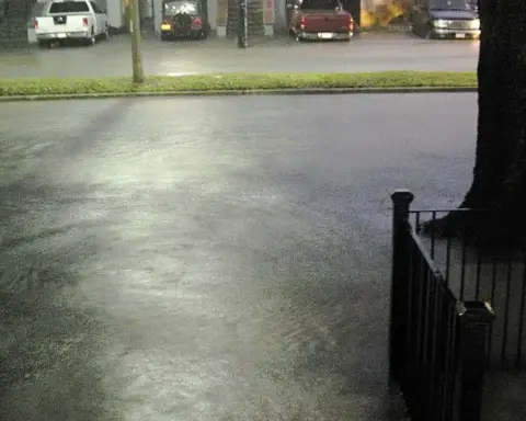 Floodwater covering an urban street after heavy rain.