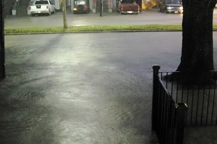 Floodwater covering an urban street after heavy rain.