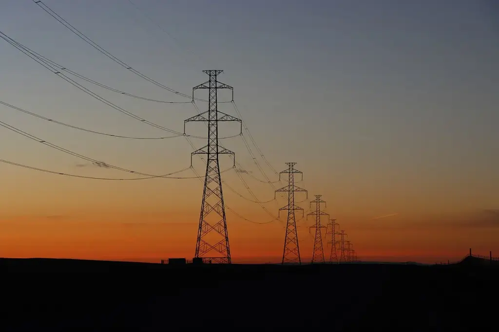 Electric transmission lines crossing the sky, used as a representative image for utility bill assistance.