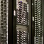 Rows of server racks representing AI compute and digital security infrastructure.