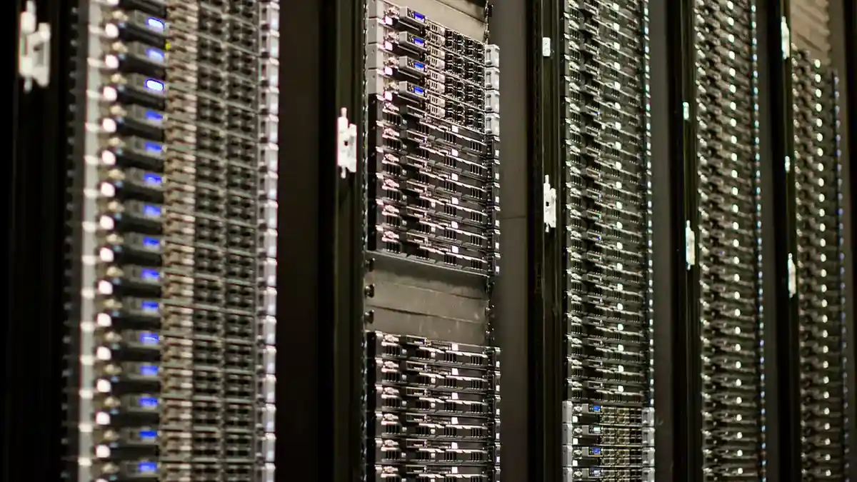 Rows of server racks representing AI compute and digital security infrastructure.