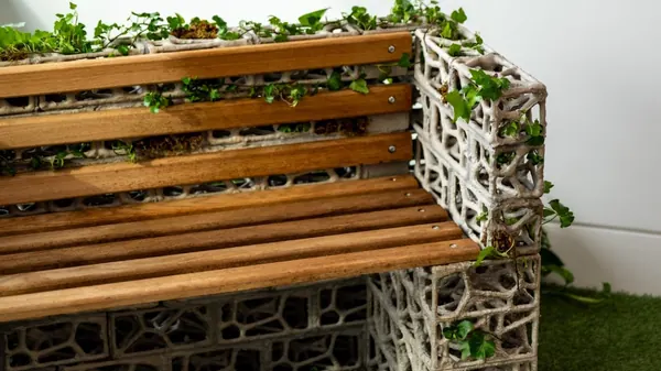 PhytoSymbiosis Seat bench in studio setting with artificial turf and white wall