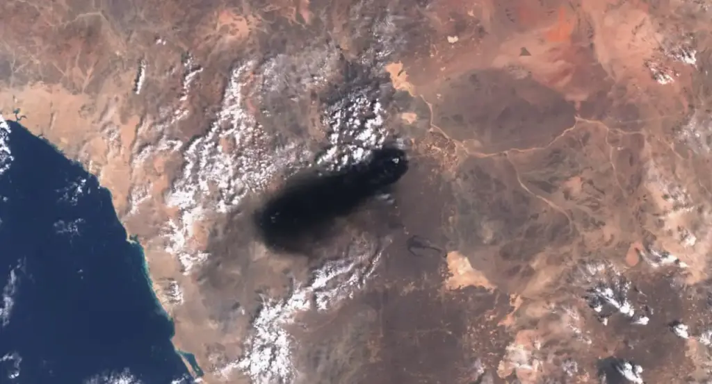 Smoke rising from the East-West Crude Oil Pipeline in Saudi Arabia, the infrastructure behind crude supply disruptions and Hormuz corridor concerns.