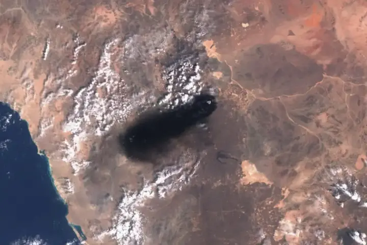 Smoke rising from the East-West Crude Oil Pipeline in Saudi Arabia, the infrastructure behind crude supply disruptions and Hormuz corridor concerns.