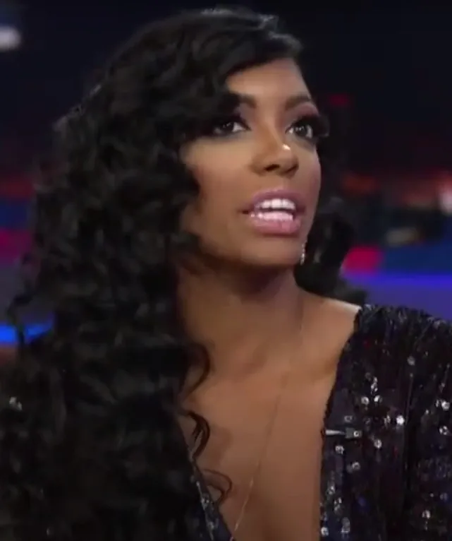 Archival photograph of television personality Porsha Williams smiling during a public studio appearance prior to her health disclosure.