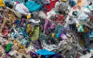 Close-up of shredded, color-sorted plastic waste ready for recycling.
