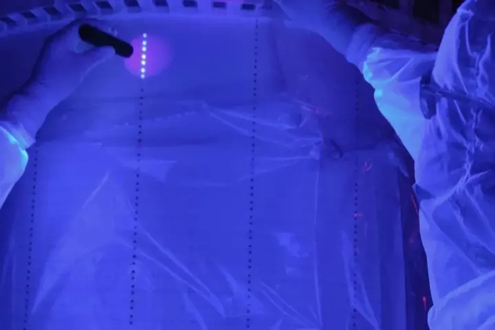 Researchers working on the LUX-ZEPLIN detector in a cleanroom.