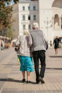 Older couple walking outdoors used for UK State Pension rise coverage.