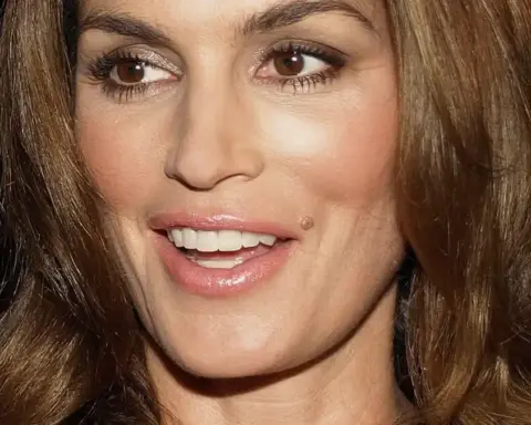 Portrait of Cindy Crawford outdoors during a media appearance.
