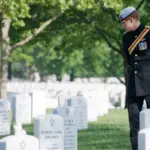 Prince Harry during a visit to Arlington National Cemetery, where he has faced security concerns affecting his children's school life.