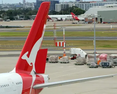 Qantas Boeing 737-800 aircraft at an Australian airport with the airline's red tail visible