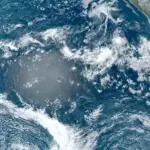 Satellite view of the Pacific Ocean from space with clouds over blue water