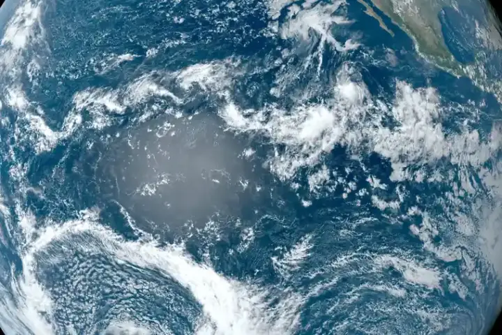 Satellite view of the Pacific Ocean from space with clouds over blue water