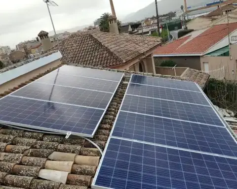 Modern silicon photovoltaic solar panels mounted on a building rooftop angled toward sunlight.