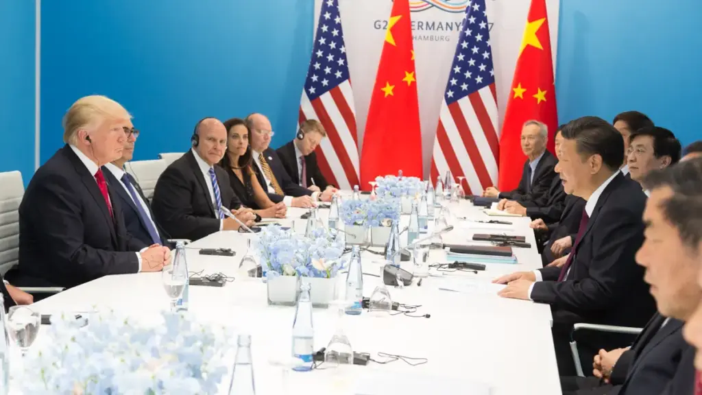 Donald Trump and Xi Jinping seated at a bilateral meeting table during a G20 diplomatic engagement.