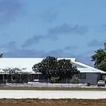 Government and parliament buildings in Yaren, Nauru, seen from across an open road and grounds.