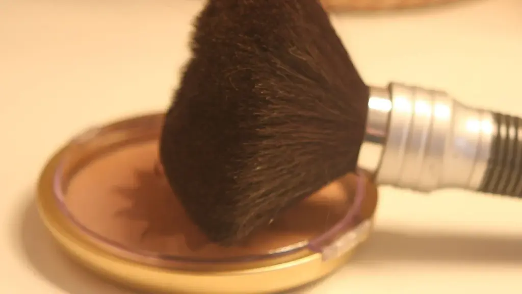 Close-up photograph of a makeup brush with cosmetic powder, representing retail beauty products.