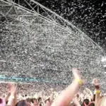Large concert crowd facing a stage at a live music event, representing the ticketing market.
