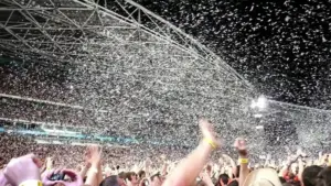 Large concert crowd facing a stage at a live music event, representing the ticketing market.