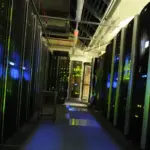 Rows of black server racks inside a data centre server room