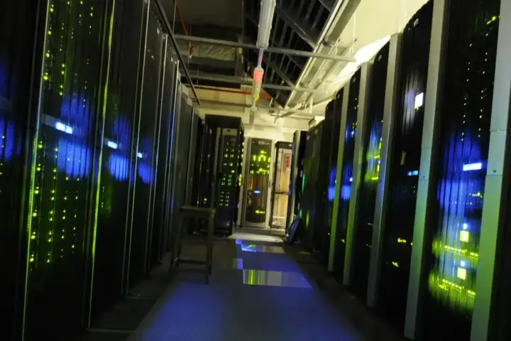 Rows of black server racks inside a data centre server room