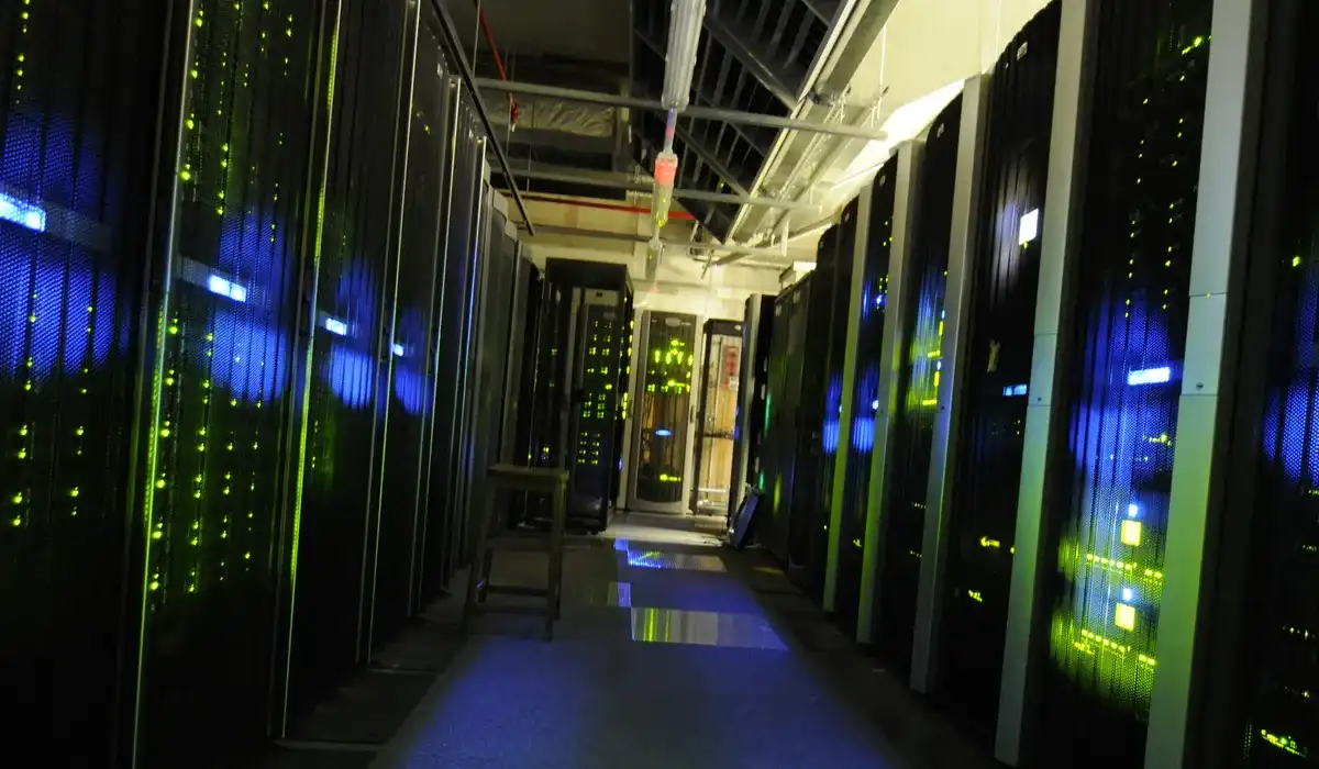 Rows of black server racks inside a data centre server room