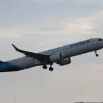 Air Transat Airbus A321 single-aisle passenger airplane parked on an airport apron with airline livery visible.