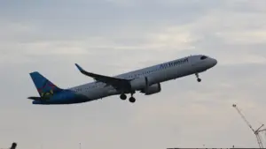 Air Transat Airbus A321 single-aisle passenger airplane parked on an airport apron with airline livery visible.
