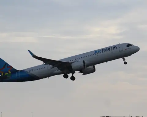 Air Transat Airbus A321 single-aisle passenger airplane parked on an airport apron with airline livery visible.