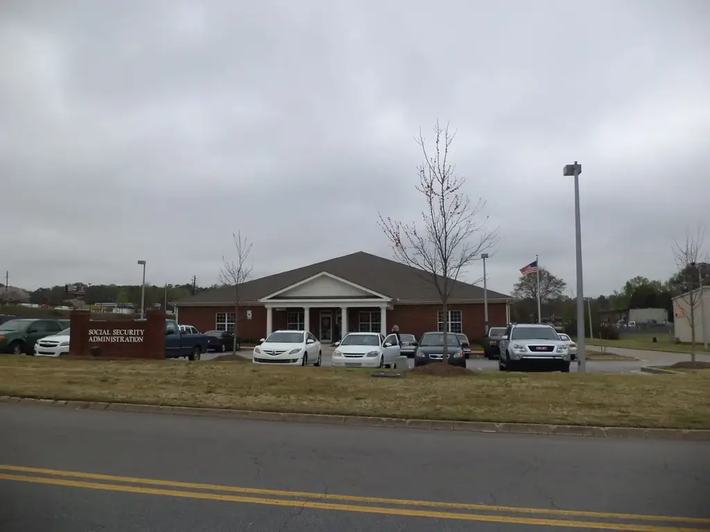 Brick exterior of an official Social Security Administration field office building with entrance signage