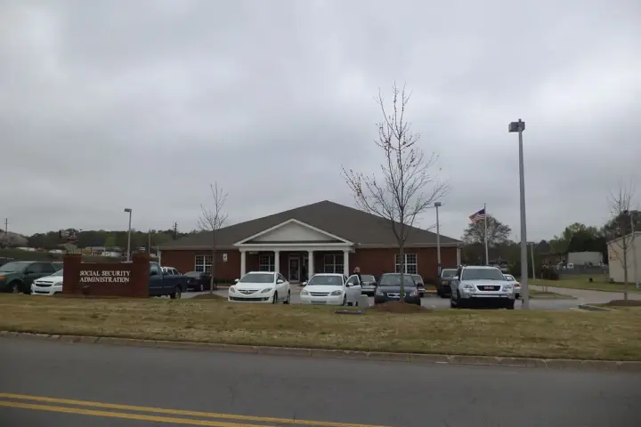 Brick exterior of an official Social Security Administration field office building with entrance signage