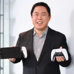 Hideaki Nishino holding PlayStation hardware in a Genki post on X