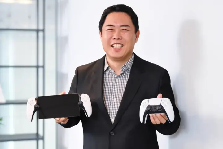 Hideaki Nishino holding PlayStation hardware in a Genki post on X