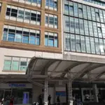 Exterior view of a modern NHS hospital building in London during daylight, used as context for hospital heat risk reporting.